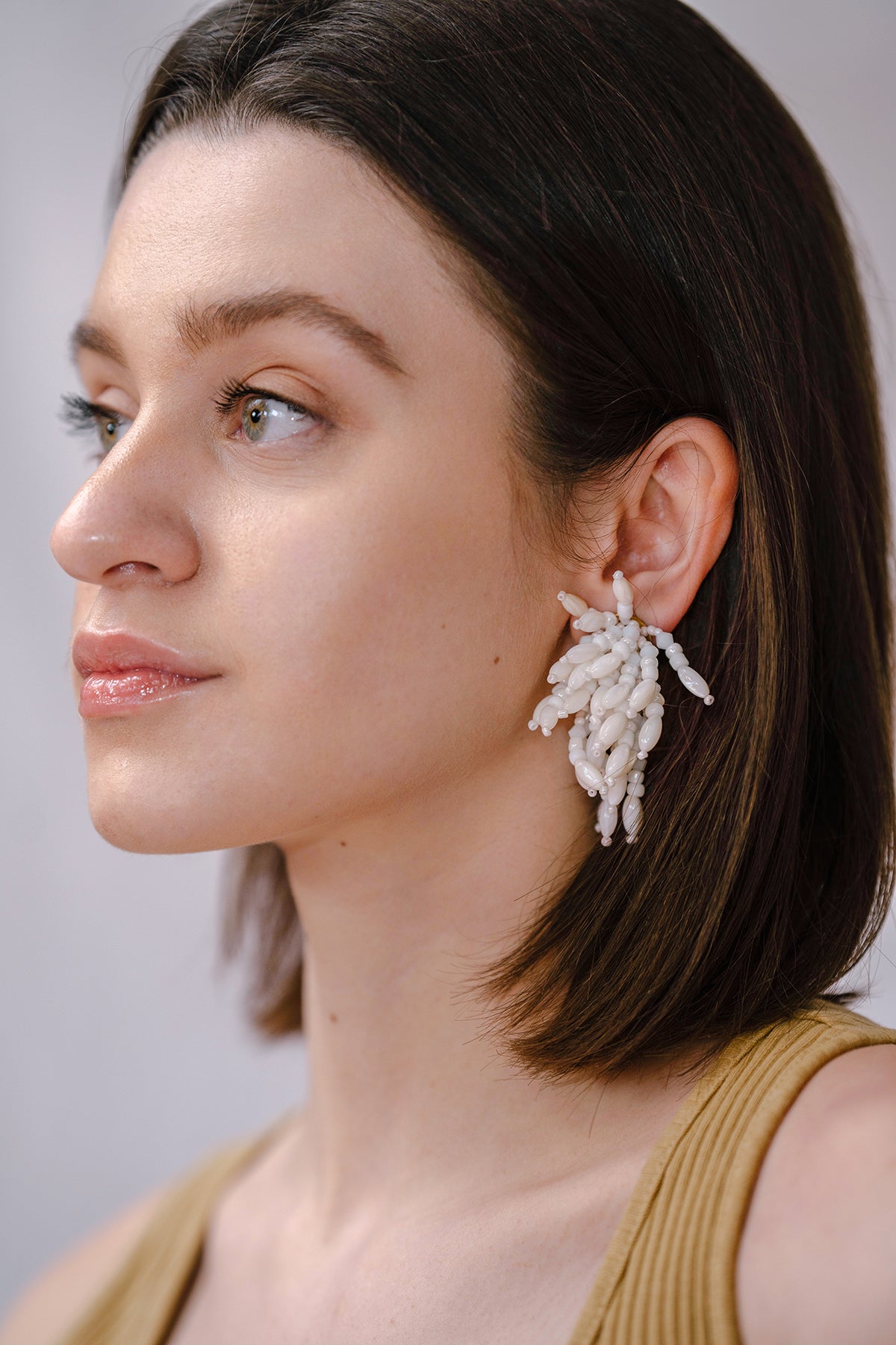 Model Wearing IK Beaded White Clip Earrings