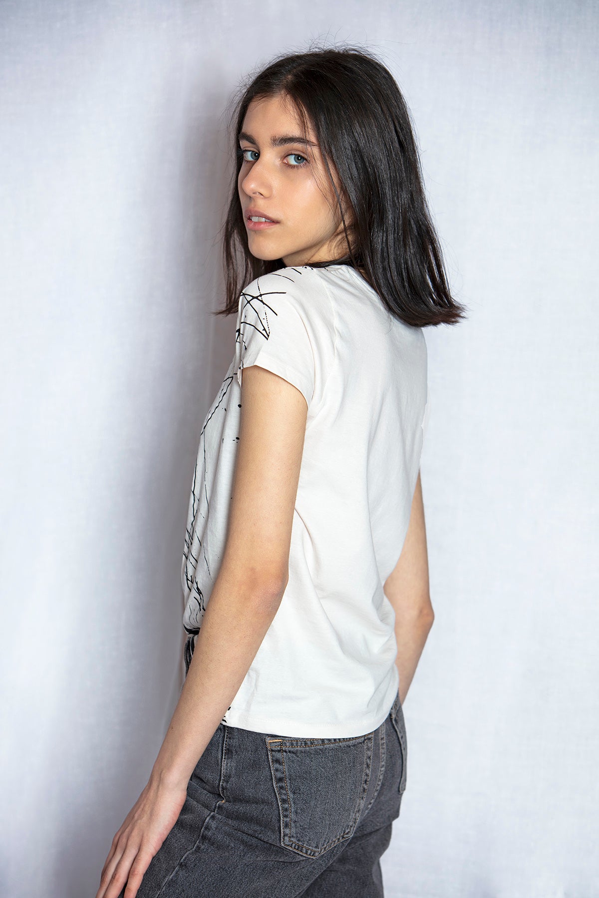  Model wearing Armine Ohanyan graphic t-shirt Aoki back view