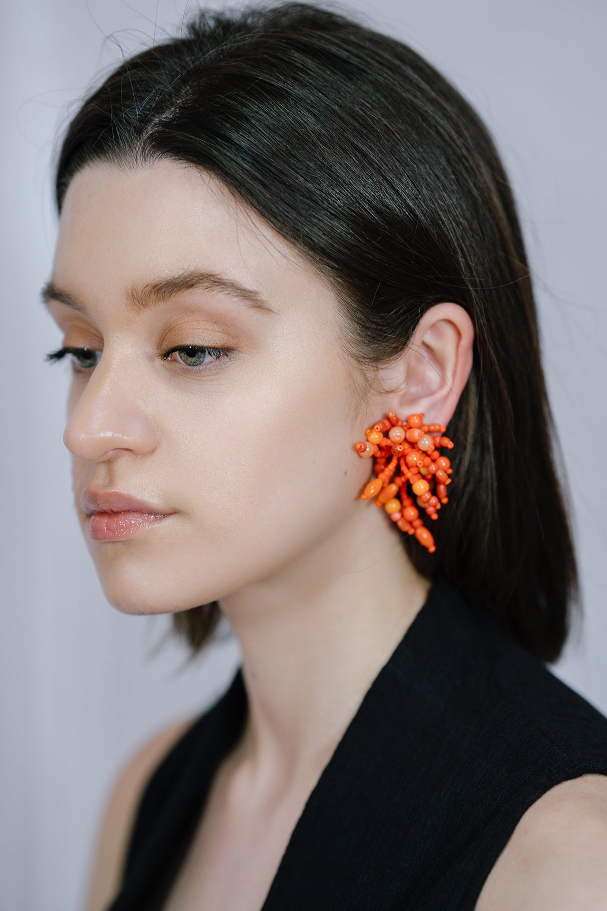 Model Wearing IK Beaded Coral Clip Earrings